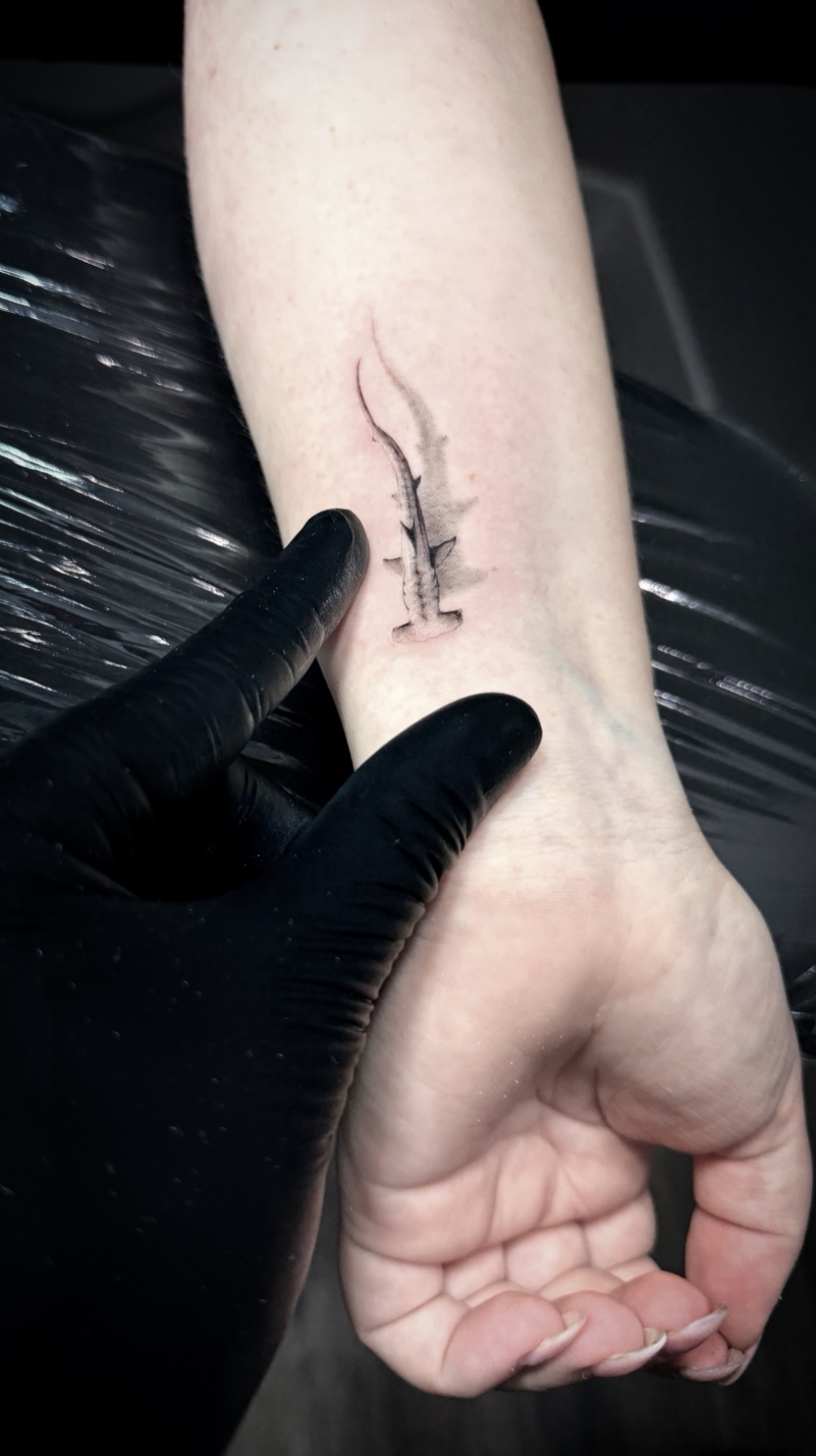 Microrealism hammerhead shark on wrist